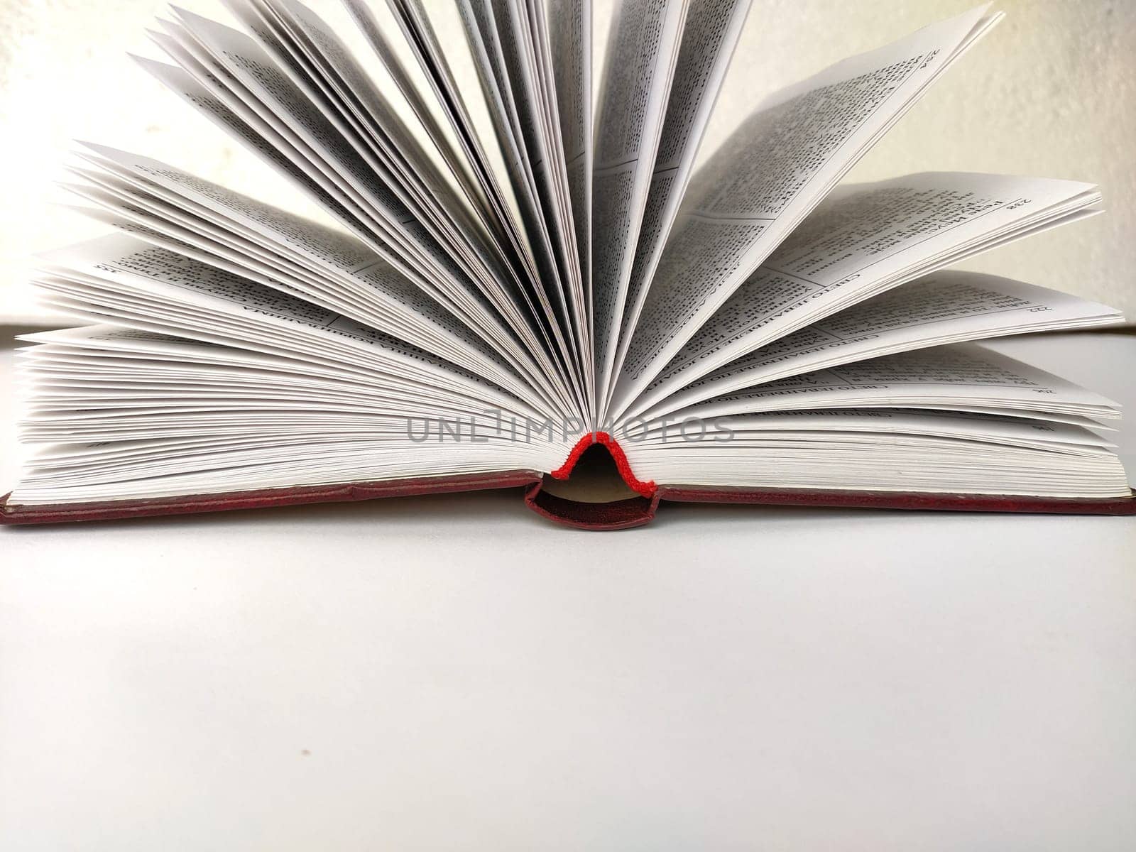 the opened book on the white table.