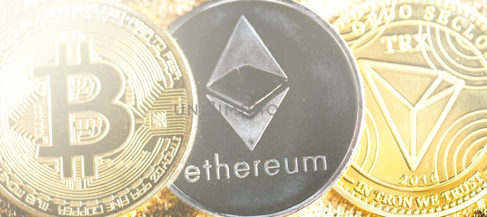 Closeup of bitcoin, ethereum and tron coins cryptocurrency background. Blockchain, virtual money and trade concept.
