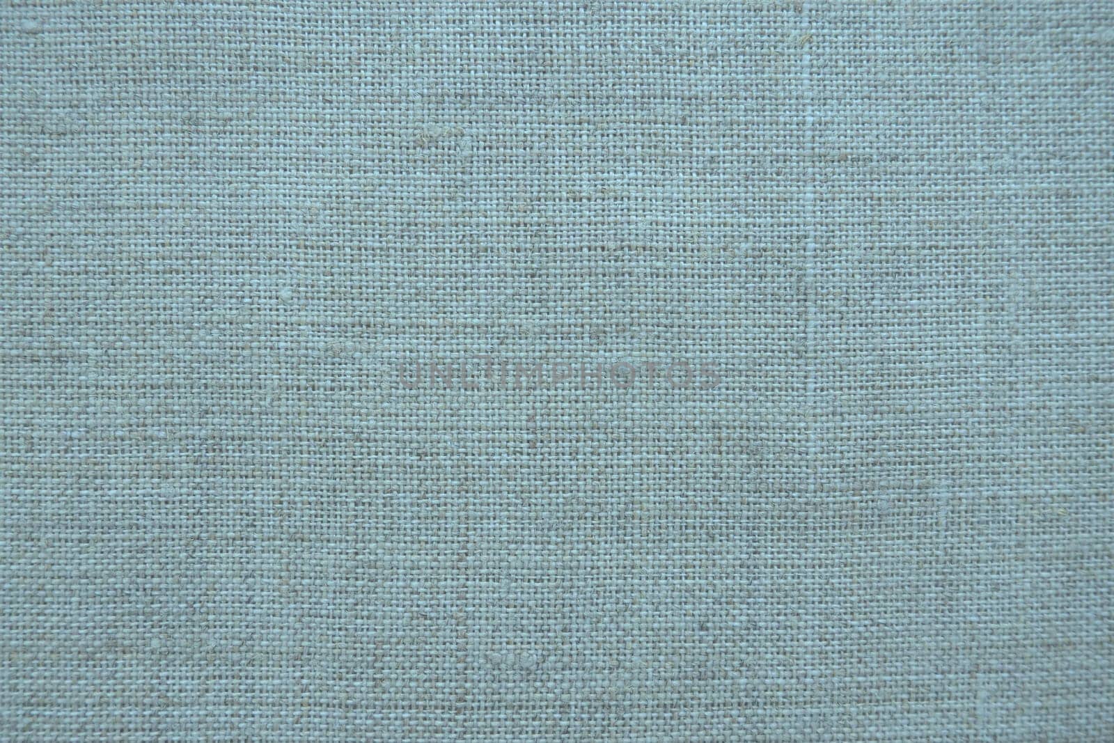 Fabric texture background. Blue fabric with weave. Natural slightly wrinkled look of the material. Uniform copy space background. Cotton, canvas or woolen thin fabric laid evenly on the surface