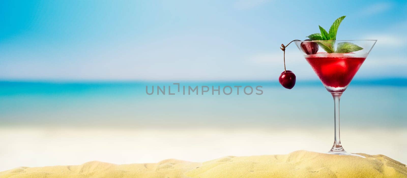 Cherry cocktail in martini glass on tropical sandy beach banner. Summer vacation holiday and beach party design. Island resort beach bar background. Happy hour drink menu.