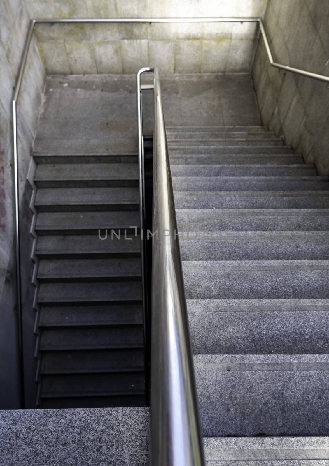 Detail of access stairs for pedestrians in a street in the city, access to the subway