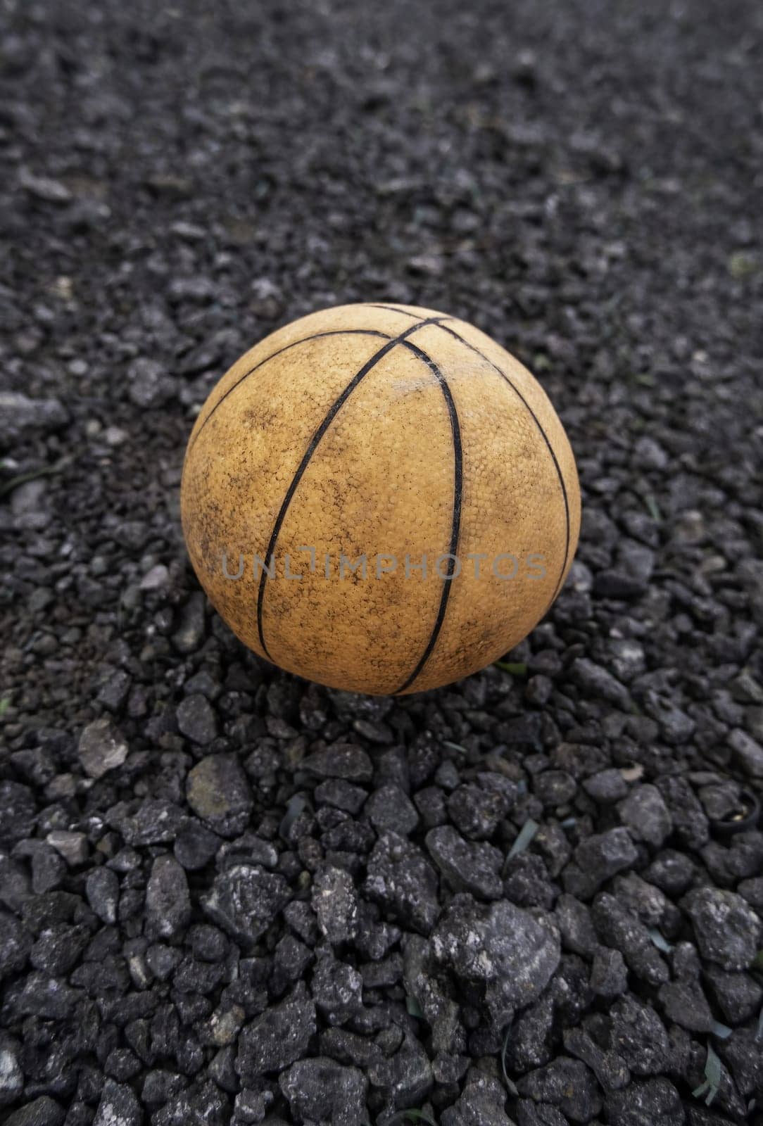 Detail of old ball to play basketball, garbage and dirt