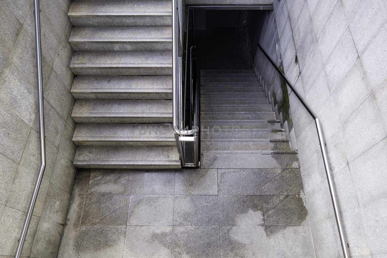Detail of access stairs for pedestrians in a street in the city, access to the subway