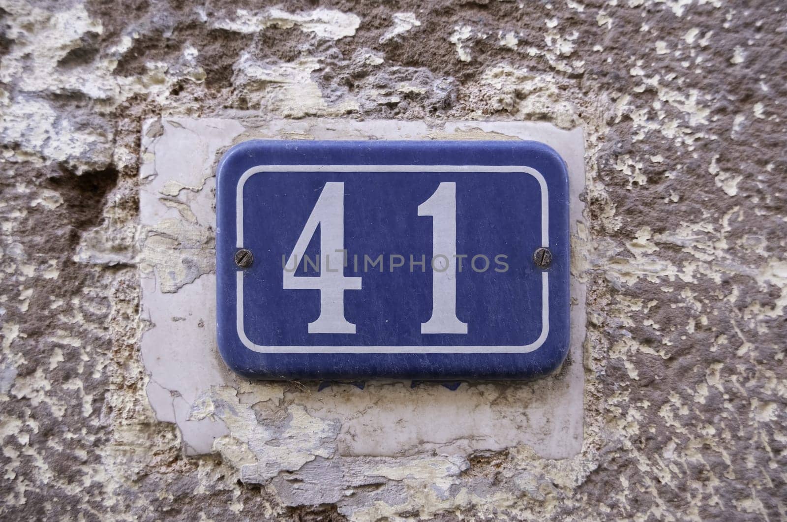 Detail of old odd number of information on a street in a town, address