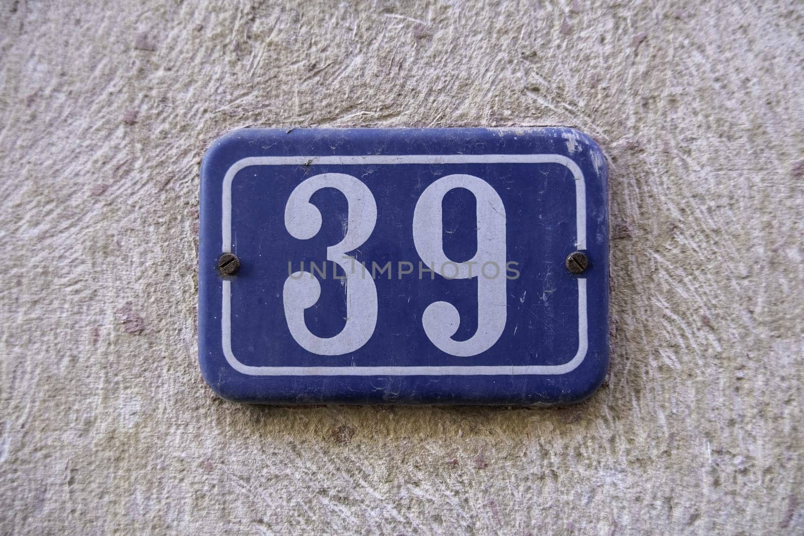 Detail of old odd number of information on a street in a town, address