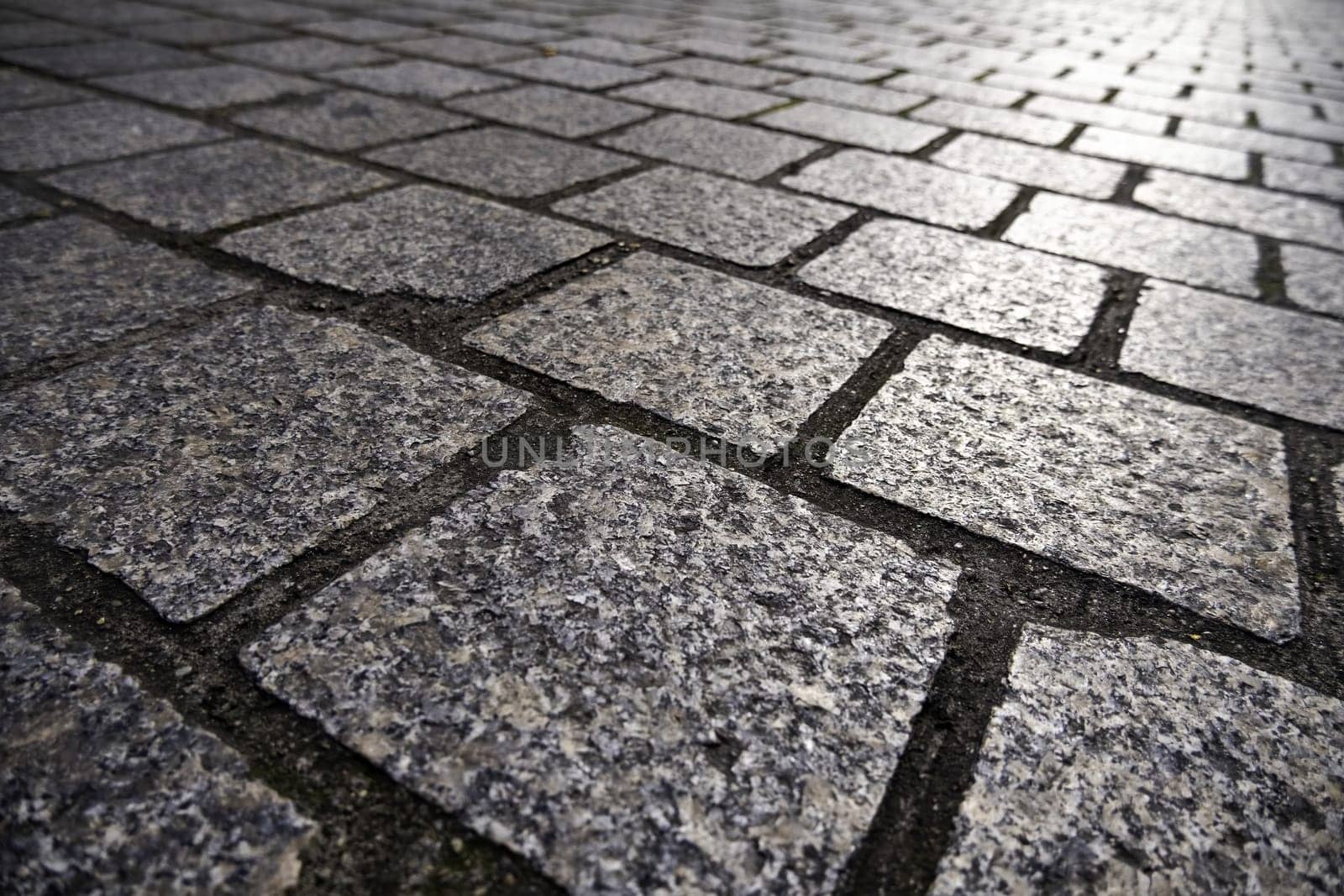 Detail of old handmade stone flooring for pedestrians