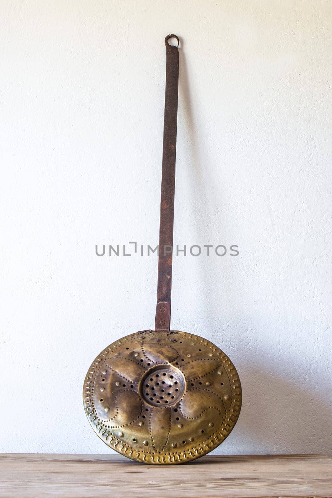 Old metal bed warmer. Country style background