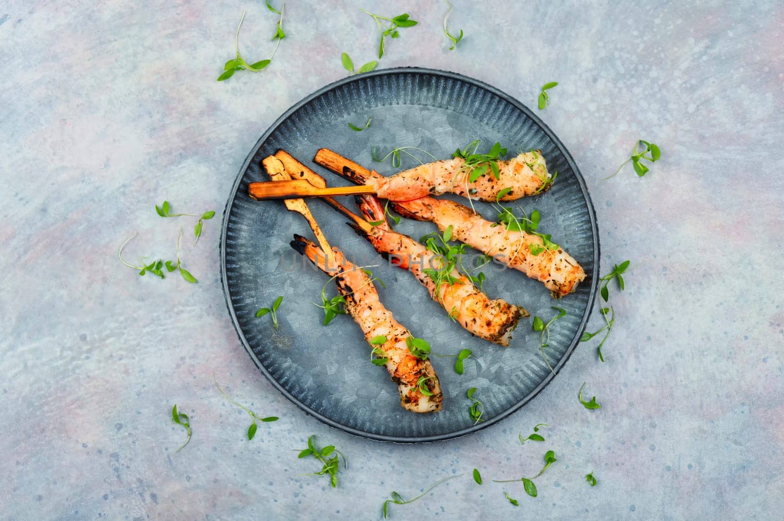 Classic shrimp or langoustines barbecue with herbs grilled on wooden sticks. Top view