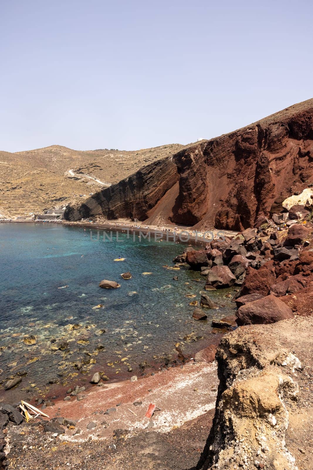 Santorini, Greece - July 01, 2021: The famous Red beach on the south coast of Santorini island, Cyclades, Aegean Sea.