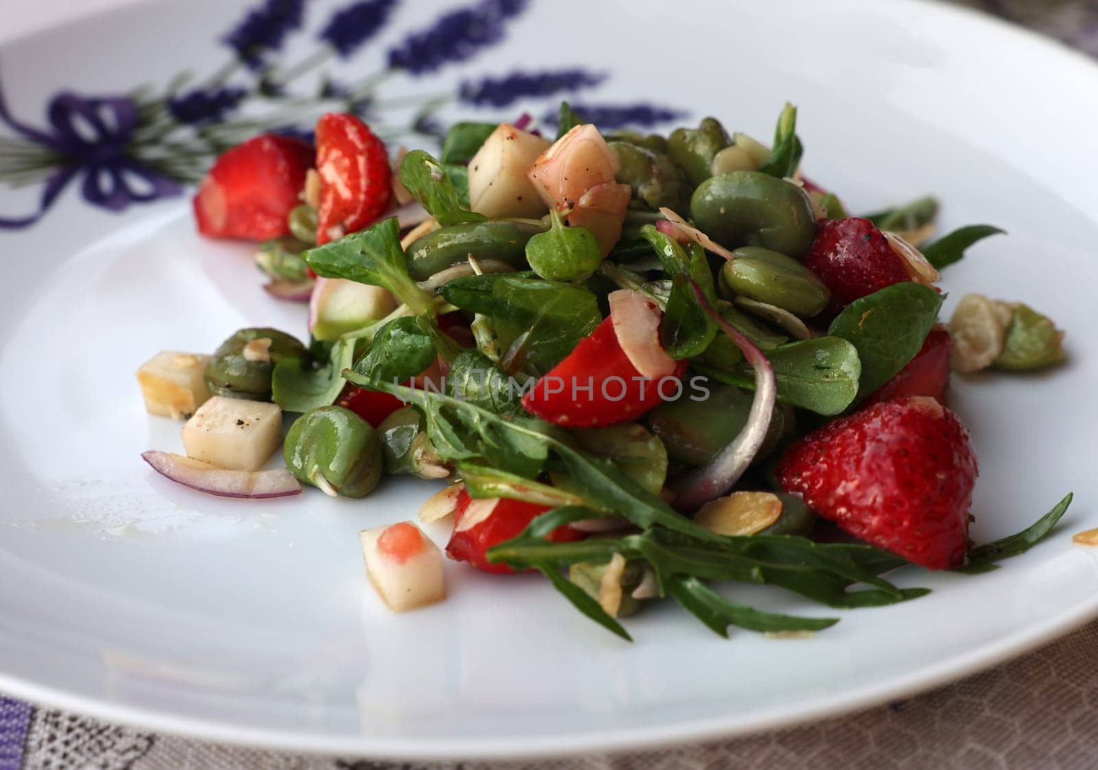 salad with strawberries and broad beans. Delicious dish in a healthy style