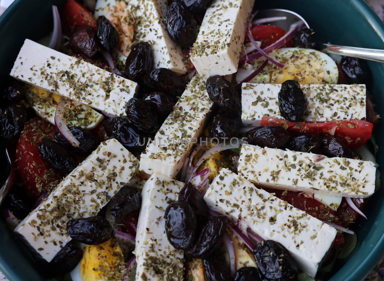 Greek salad with feta cheese and black olives. Typical delicious greek style lunch
