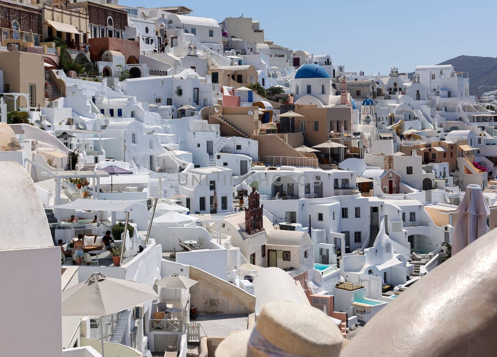 Oia, Santorini, Greece - July 3, 2021: Whitewashed houses in Oia on Santorini island, Cyclades, Greece