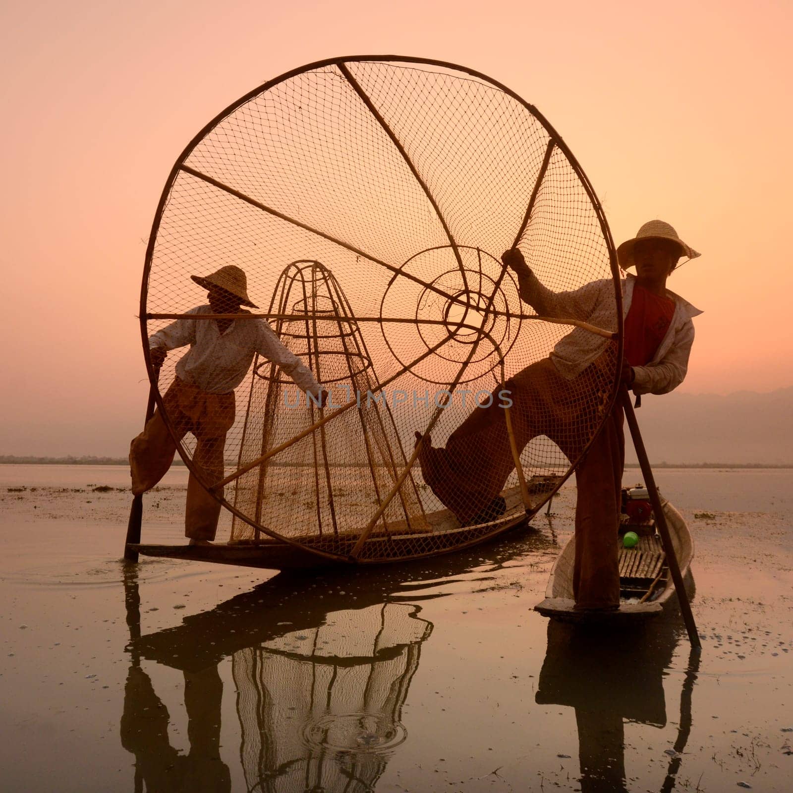Fishermen at sunrise in the Landscape on the Inle Lake in the Shan State in the east of Myanmar in Southeastasia.