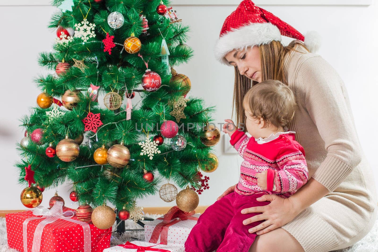 Christmas Happy Family mother and her little daughter open Holidays Gift.