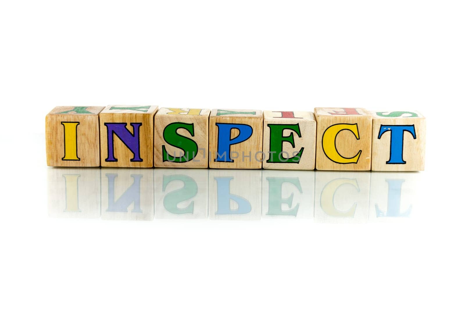 inspect colorful wooden word block on the white background