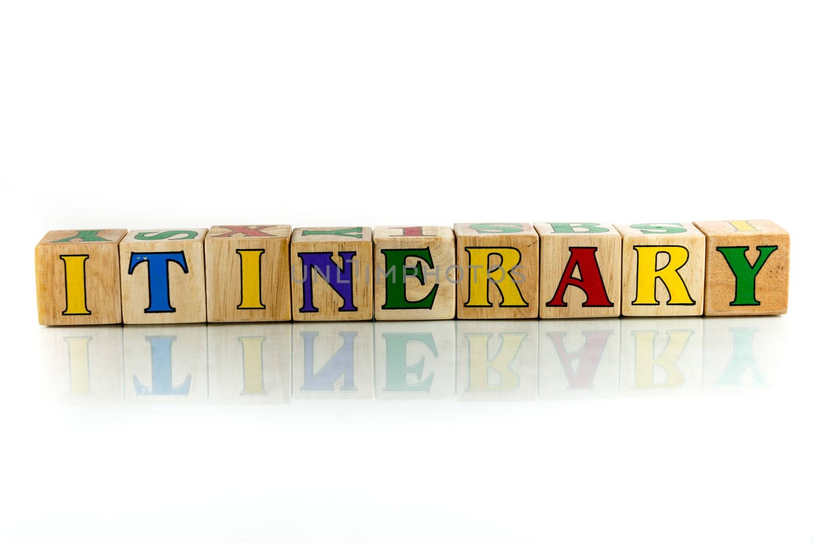 itinerary colorful wooden word block on the white background