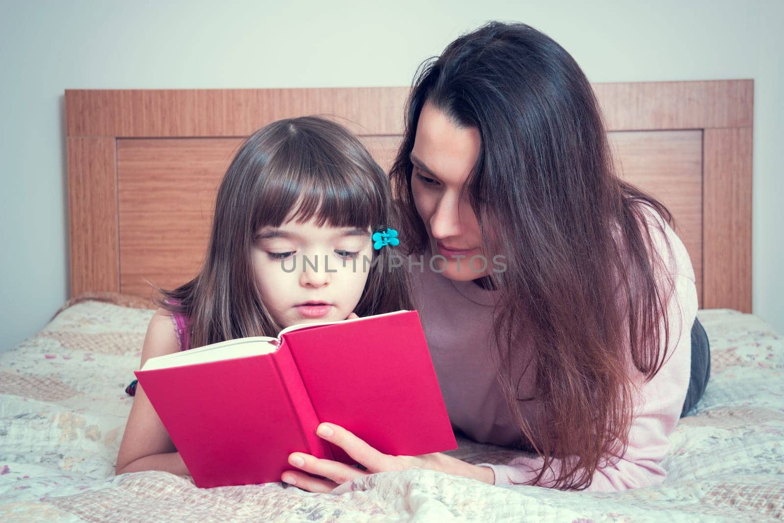 Mom with the daughter reading together