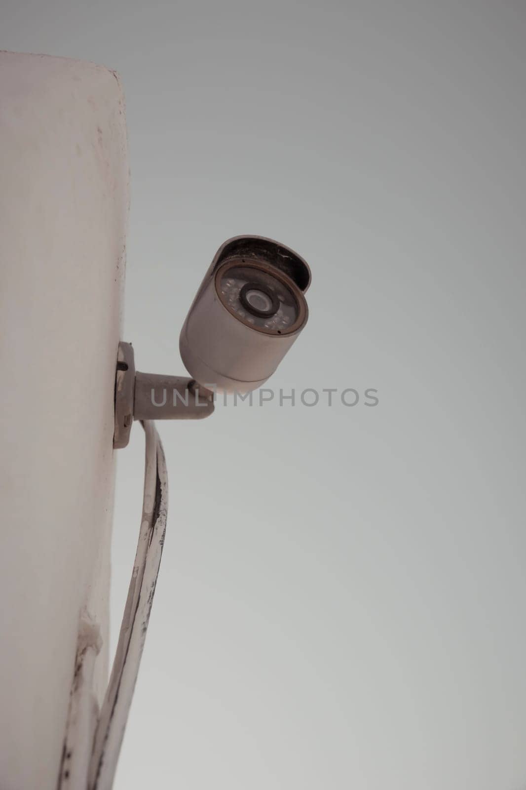 Vertical shot of a domestic security camera mounted against a wall protecting against burglary