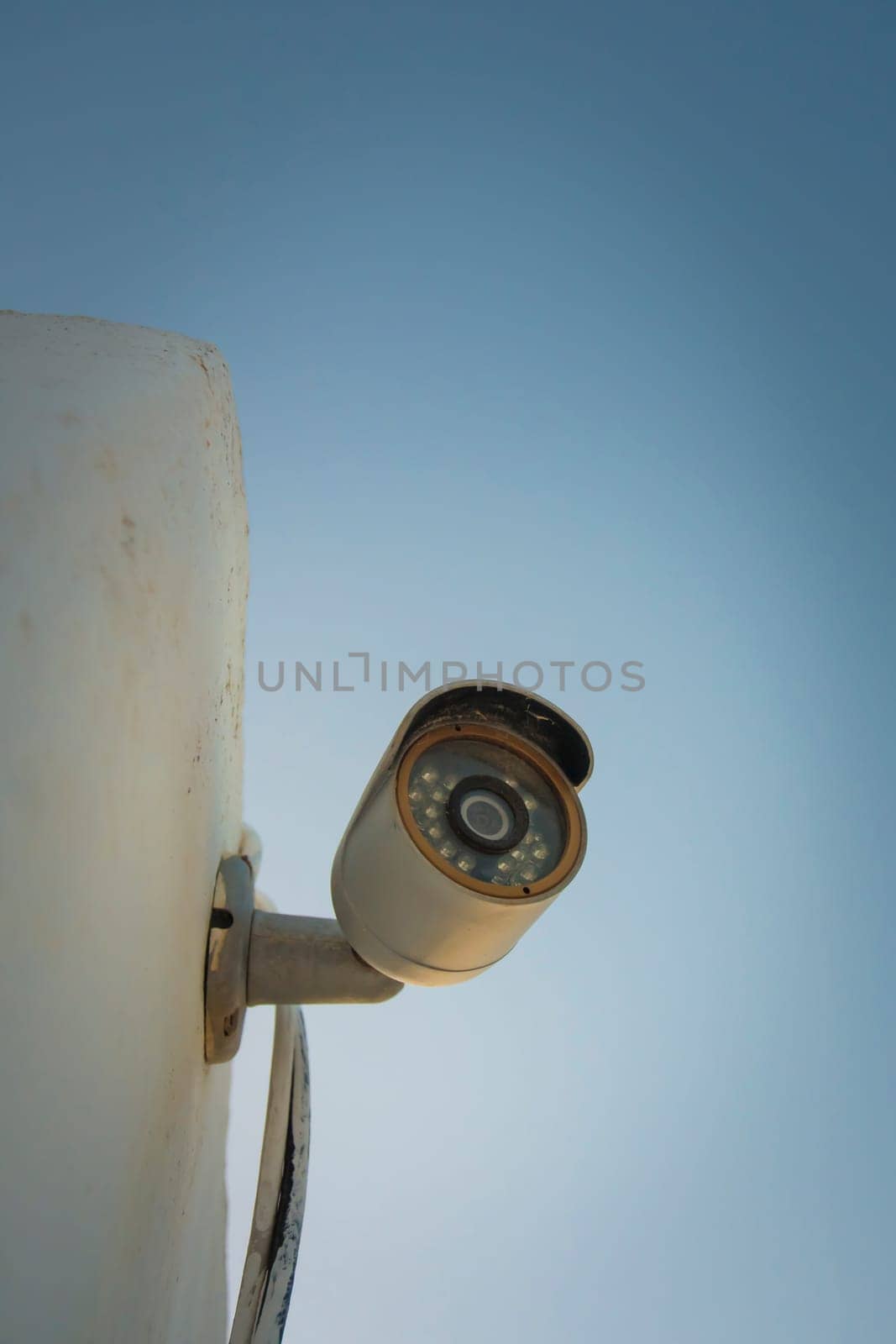 Vertical shot of a domestic security camera mounted against a wall protecting against burglary