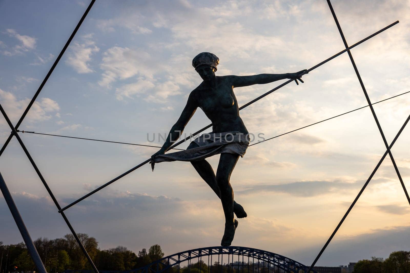 Cracow, Poland - May 2, 2022: Balancing sculptures between sky and water by Jerzy Kedziora over the Kornatka footbridge over the Vistula River in Krakow