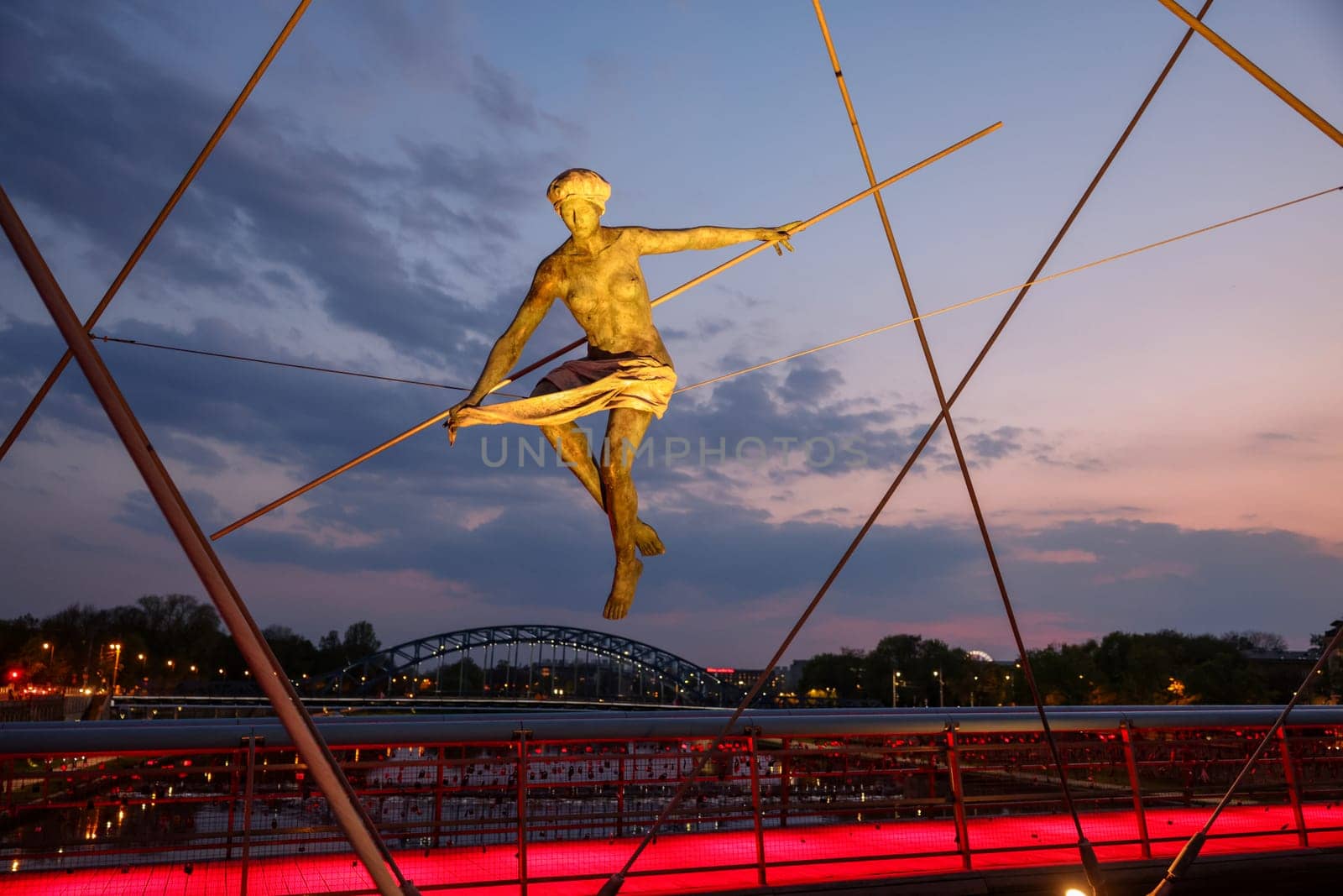 Cracow, Poland - May 2, 2022: Balancing sculptures between sky and water by Jerzy Kedziora over the Kornatka footbridge over the Vistula River in Krakow
