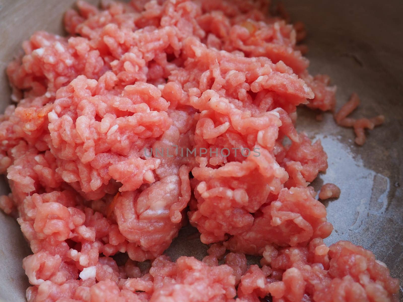Minced meat in a metal saucepan. Delicious fresh ground meat for making cutlets, steaks, hamburgers, meatballs