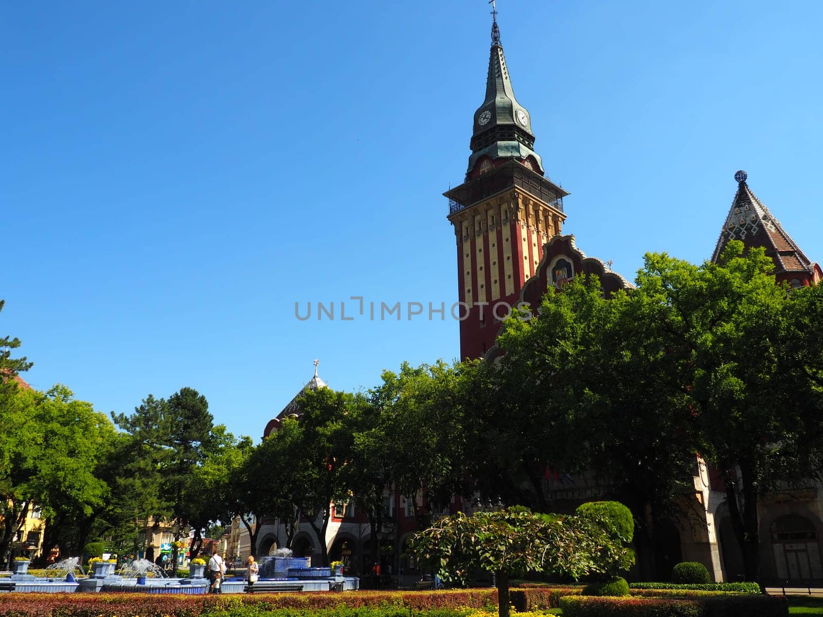 Subotica, Serbia September 12, 2021. Blue fountain in the square next to the Town Hall. Blue ceramic parts with monograms. A working fountain with splashing water. Summer sunny day by the blue water