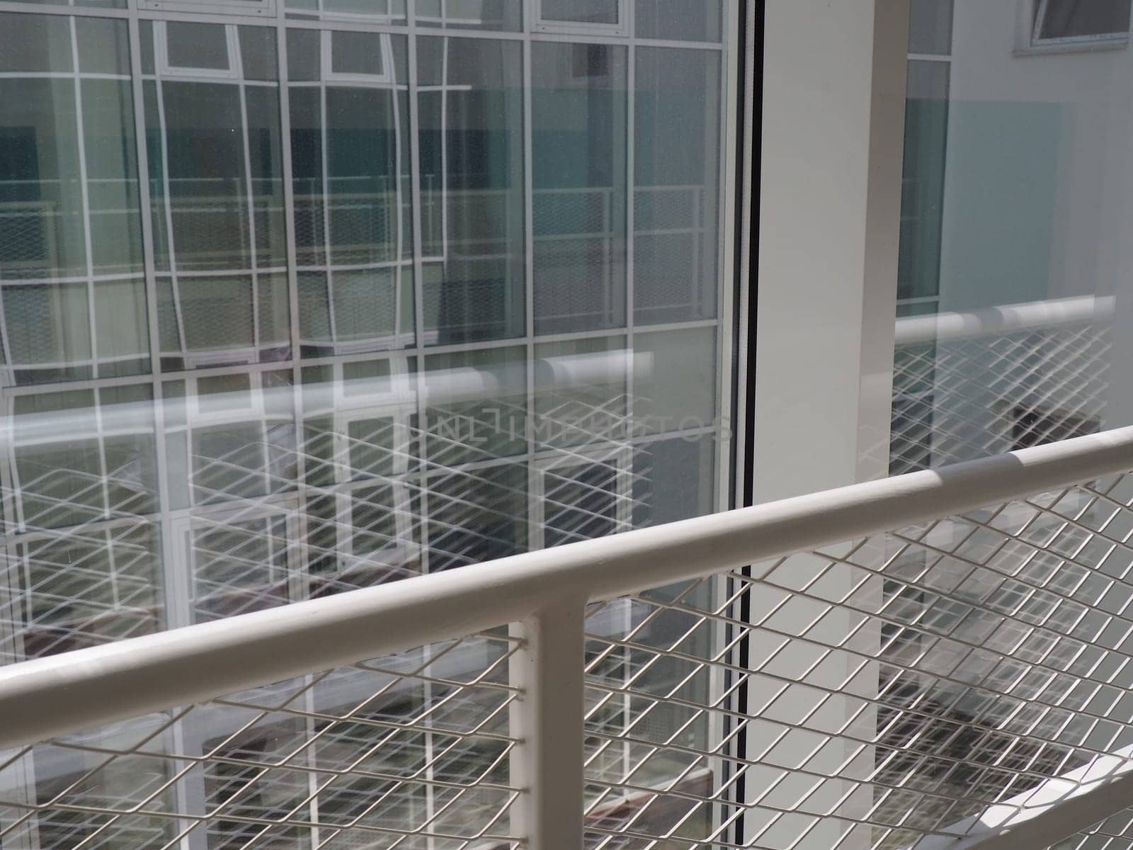 New white frames and windows. Metal fence for the safety of schoolchildren. New modern school. View from the window to the opposite wall and windows. Security systems. Internal office interior