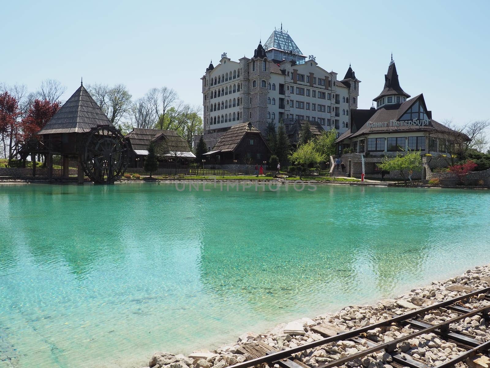 Stanisici, Bijelina, Republika Srpska, Bosnia and Herzegovina April 25 2021 Ethno village, tourism and attractions. Stone and wooden buildings of the hotel. People visit restaurant, traditional houses