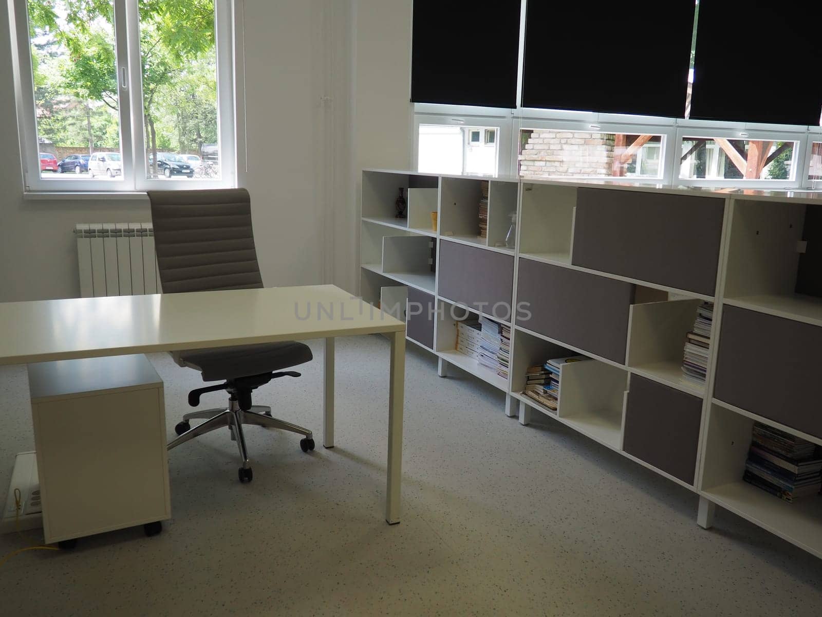 Sremska Mitrovica, Serbia, May 15, 2021 Interior of the school library. Modern school equipment. Equipment of the school and the learning process. Bookshelves. Blackout curtains and blinds on windows