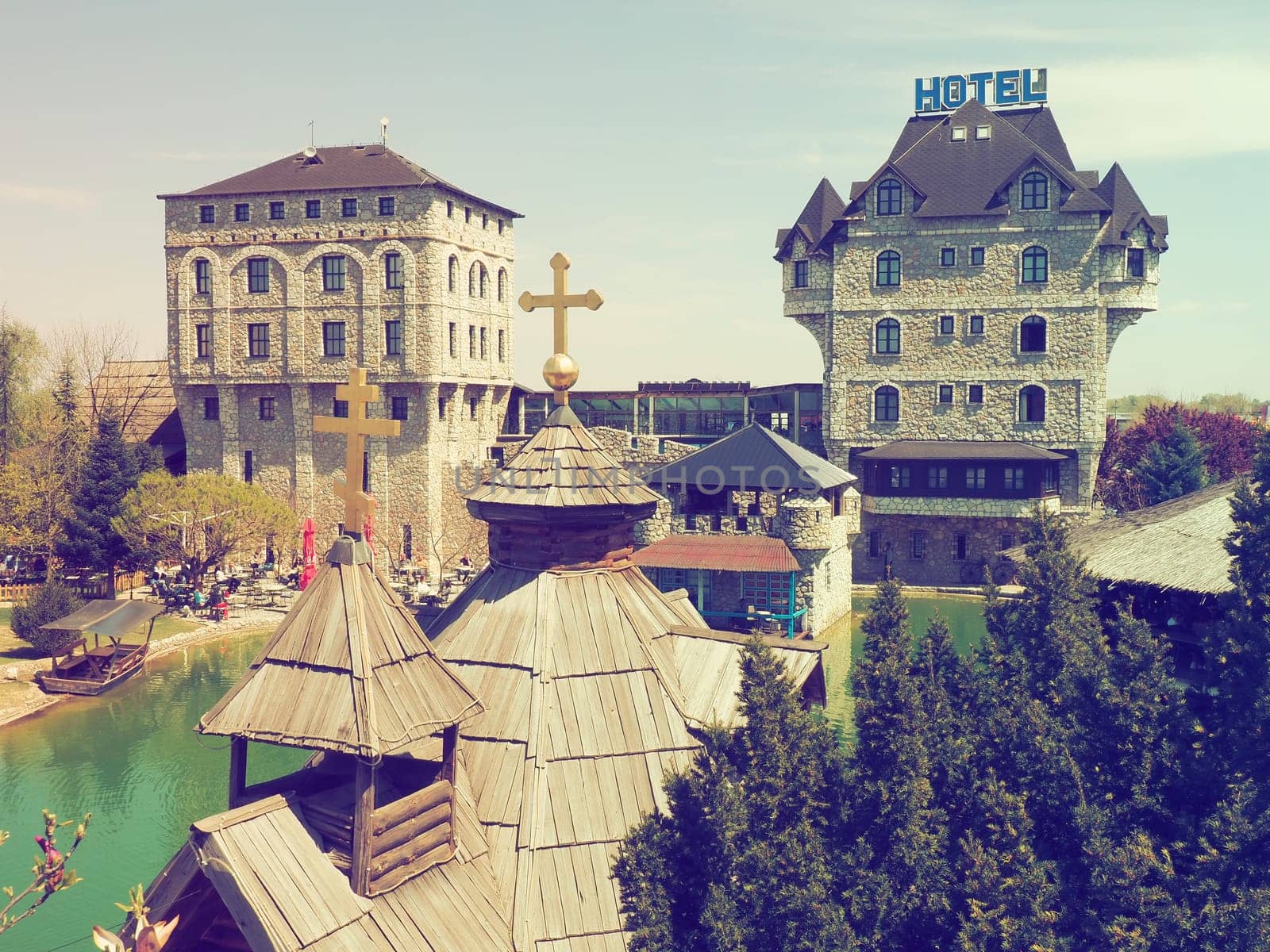Stanisici, Bijelina, Republika Srpska, Bosnia and Herzegovina April 25 2021 Ethno village, tourism and attractions. Stone and wooden buildings of the hotel. People visit restaurant, traditional houses