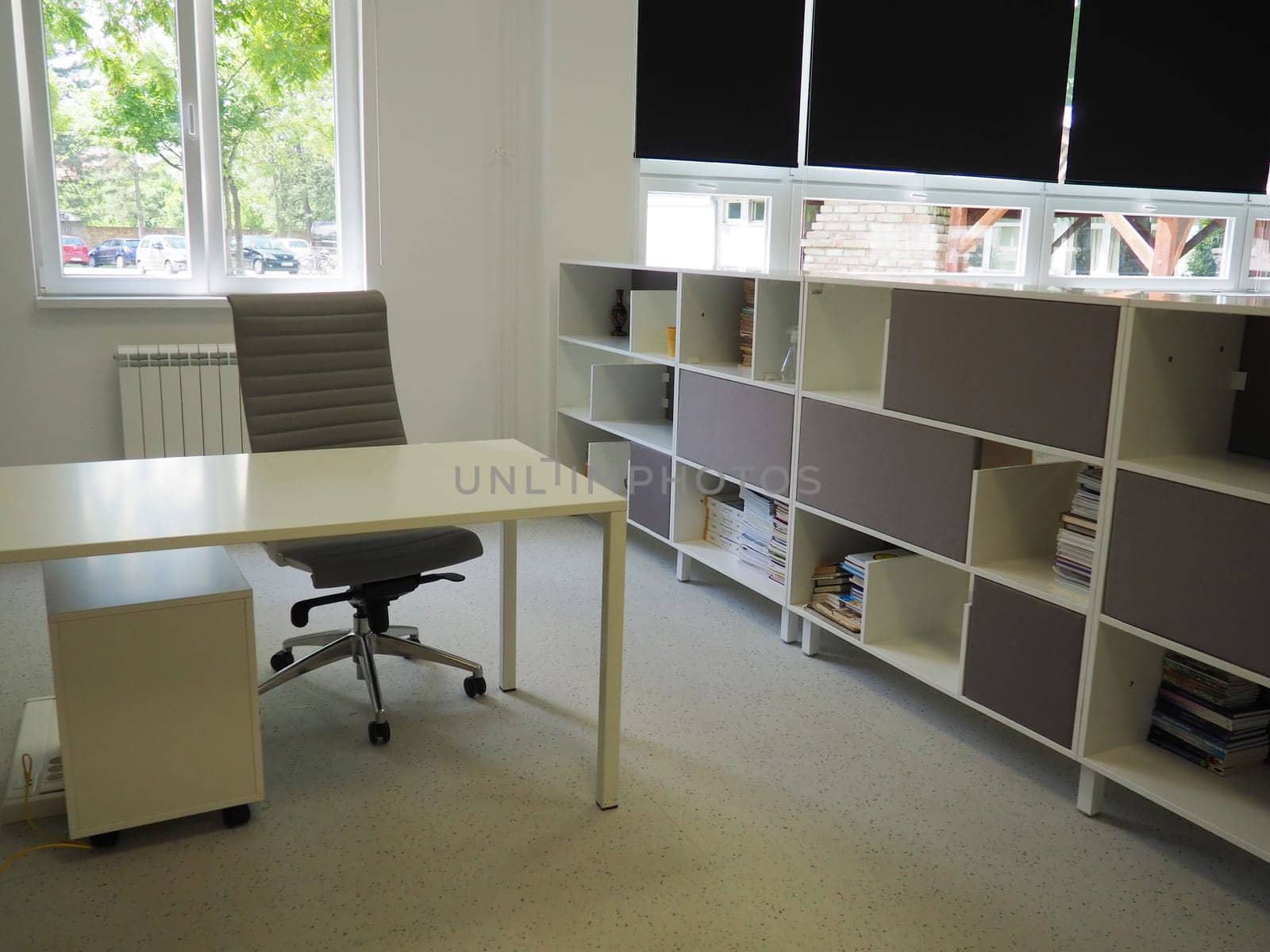 Sremska Mitrovica, Serbia, May 15, 2021. Interior of the school library. Modern school equipment. Equipment of the school and the learning process. Bookshelves. Blackout curtains and blinds on windows.