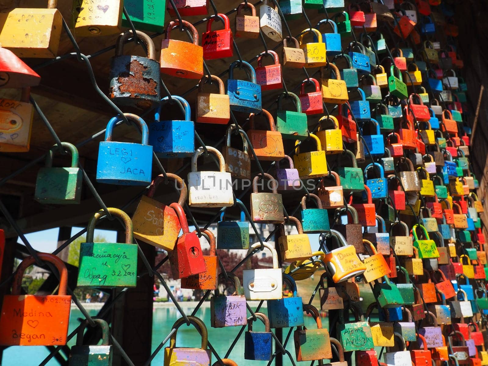 Stanisici, Bijelina, Bosnia and Herzegovina. April 25, 2021 Locks of love on a metal mesh. Many colorful beautiful castles were left by young wives and lovers. Locks hang from the fence.