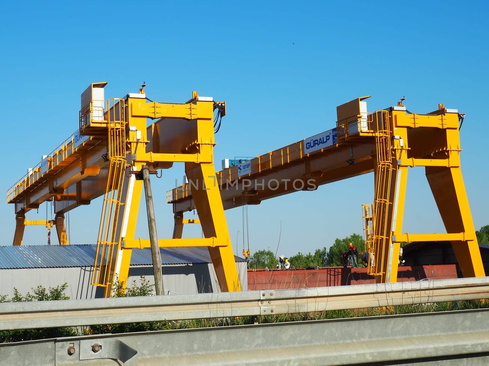 Sremska Raca, 25 April 2021. Construction of a bridge on the Sava river, crane operation, beams and concrete structures. Infrastructure project auto route Belgrade - Sarajevo. Road construction works.