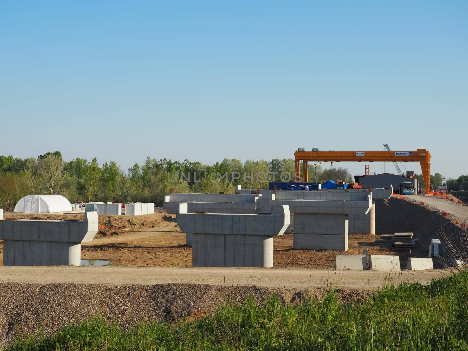 Sremska Raca, 25 April 2021. Construction of a bridge on the Sava river, crane operation, beams and concrete structures. Infrastructure project auto route Belgrade - Sarajevo. Road construction works.