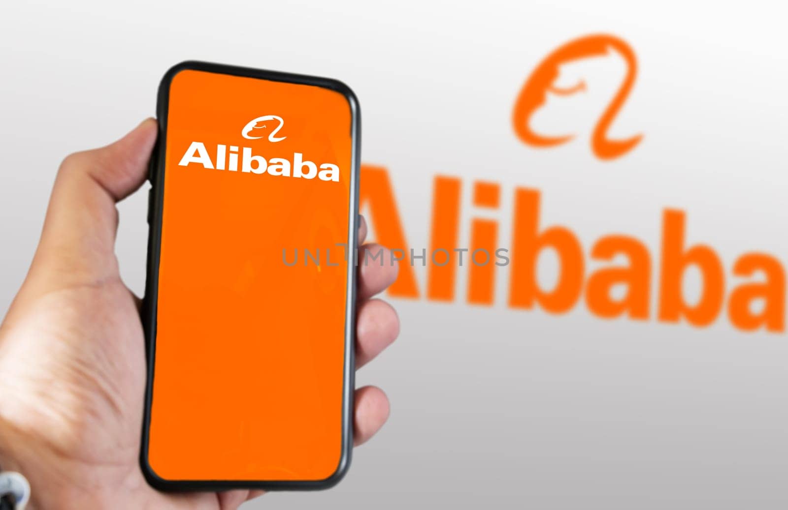 Beijing, CN, March 2023: hand holding a phone with Alibaba mobile app on the screen. On march 2023 Alibaba Gourp has decided to split its business into 6 separate units. Illustrative editorial