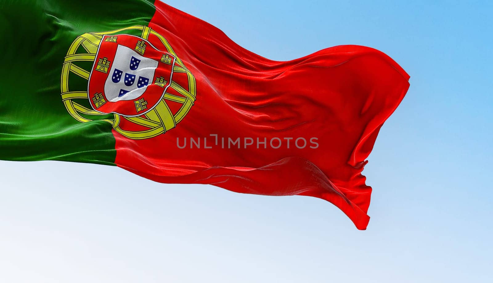 Portugal national flag waving in the wind on a clear day. Portuguese Republic is a Member State of the European Union. 3d illustration render. Rippled textile