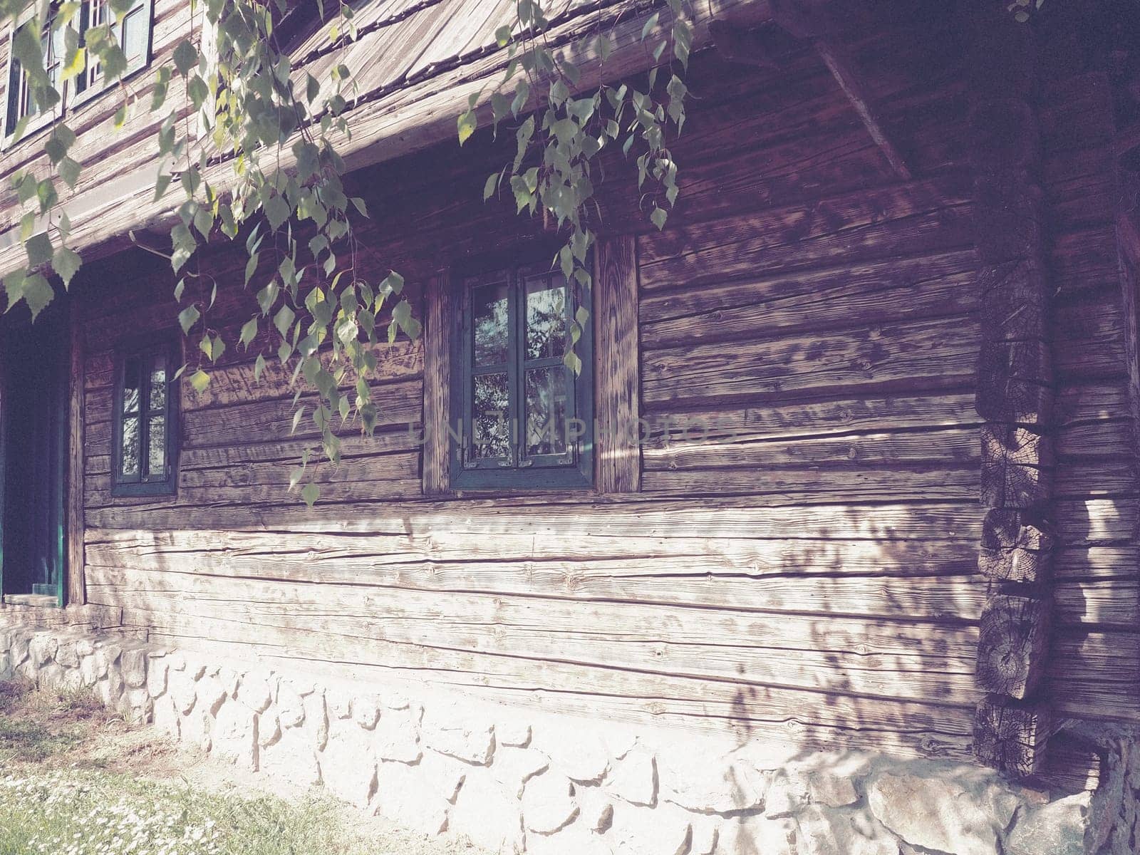 Log village farmhouse. 19th century Bosnian mountain traditional dwelling. Restored ethno building, implements of agricultural labor