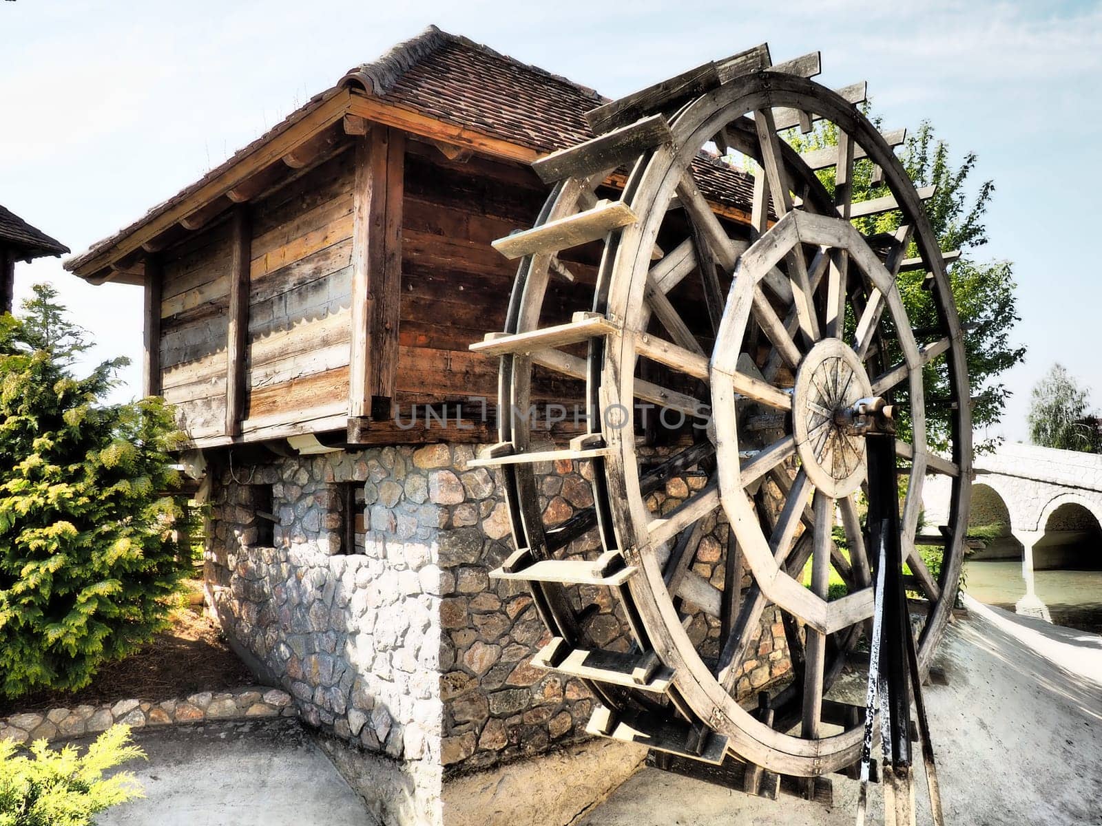 Wooden water mill. A hydraulic structure using hydropower from a water wheel. Useful work by means of a gear train.
