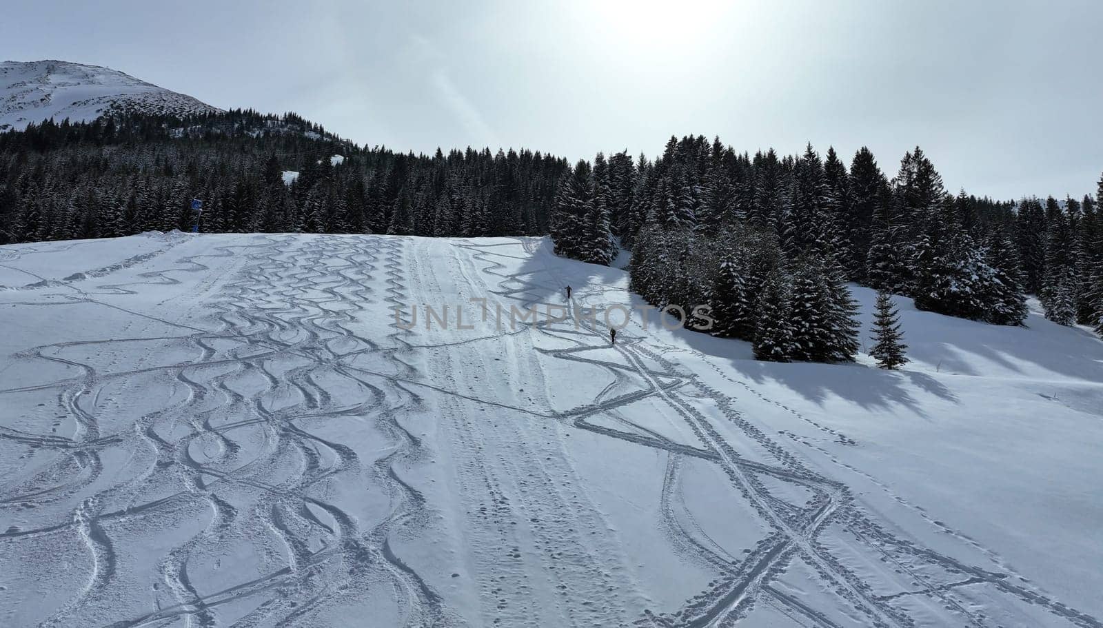 Aerial photo with drone of ski resort in winter with two ski tourers