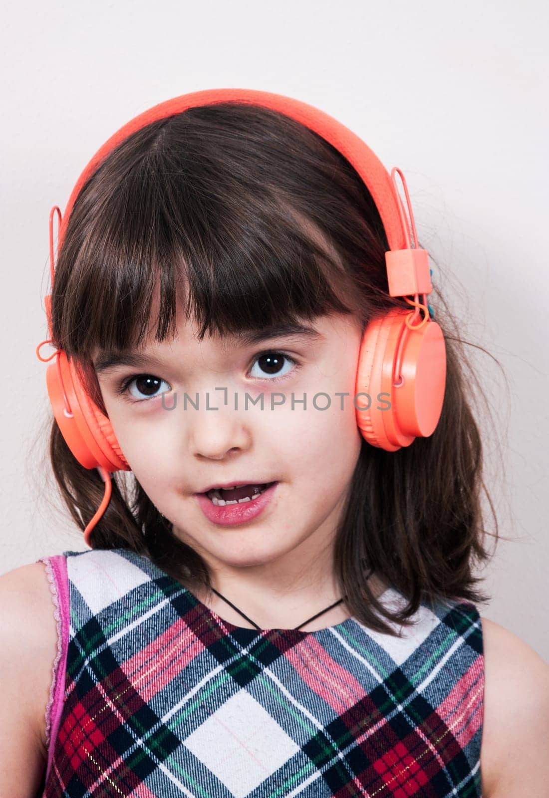 Little girl using the earphones