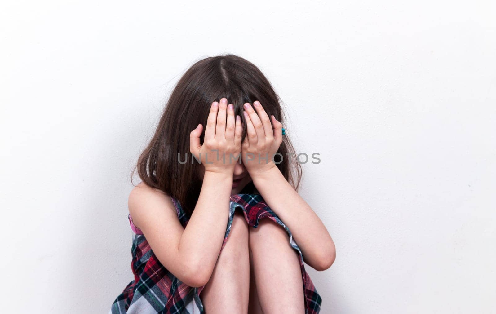 Small girl sitting in depression