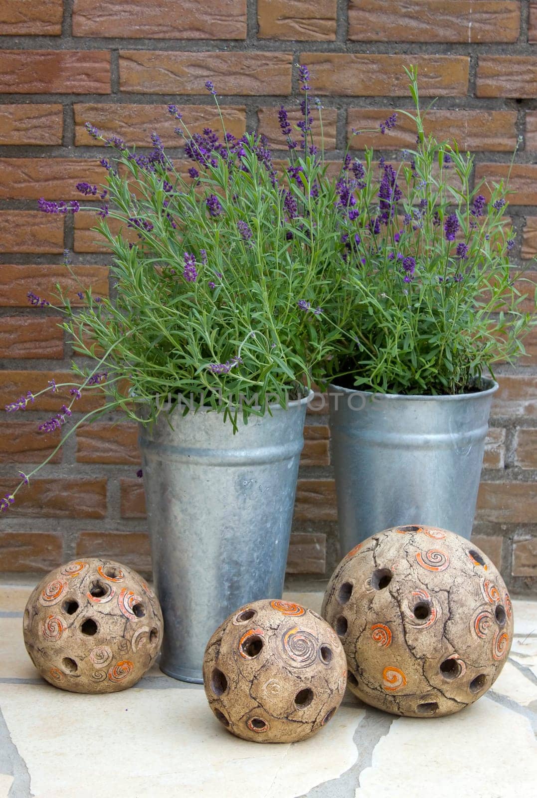 lavender flowers in metal pots and clay deco