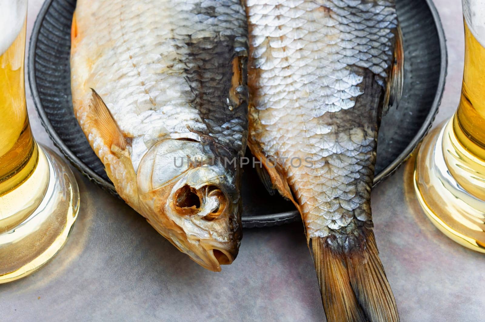Two dried salted fish on the wooden table.Stockfish