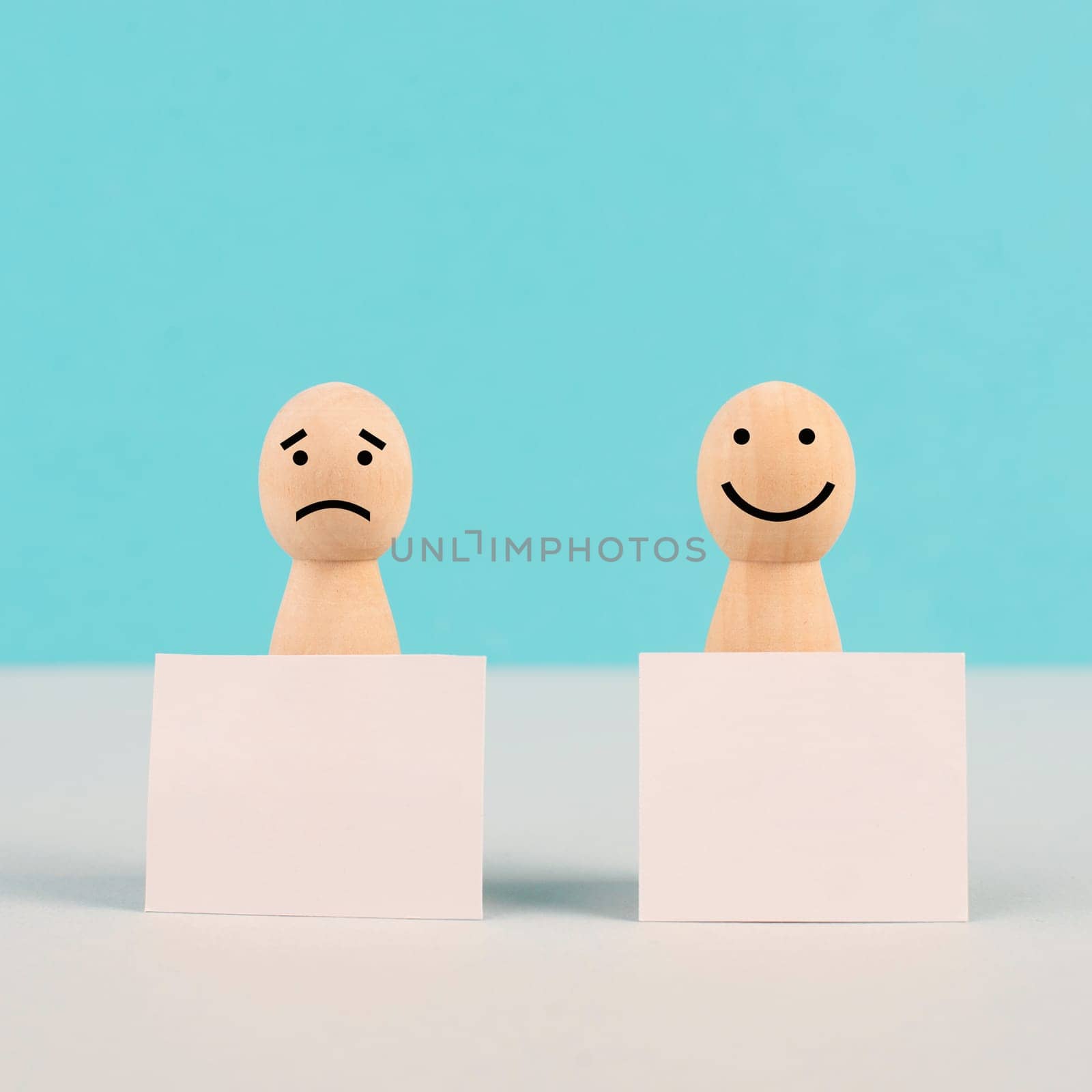 Man with a sad and a happy face holding empty signs, positive and negative mindset, support and evaluation, emotion and mental health
