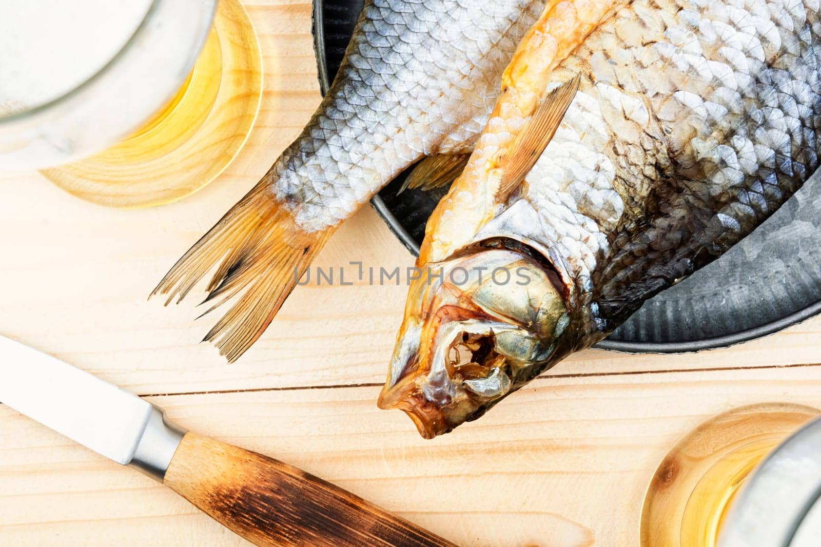 Two dried salted fish on the wooden table.Stockfish