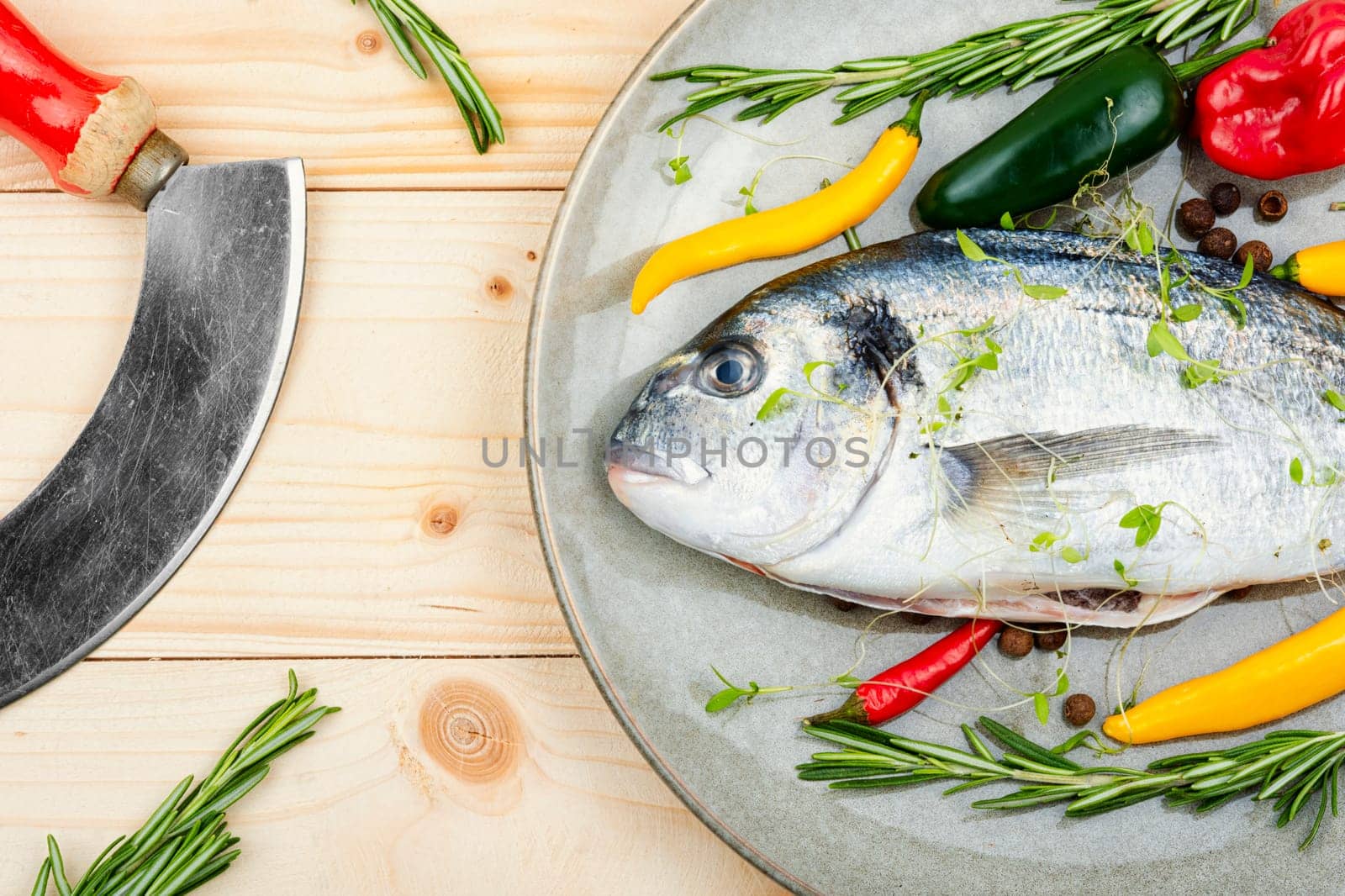 Uncooked dorado fish with ingredients for cooking. Top view