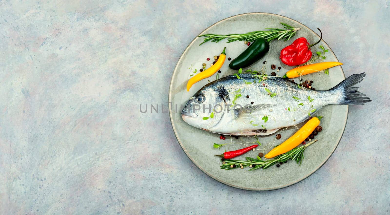 Uncooked dorado fish with ingredients for cooking. Top view