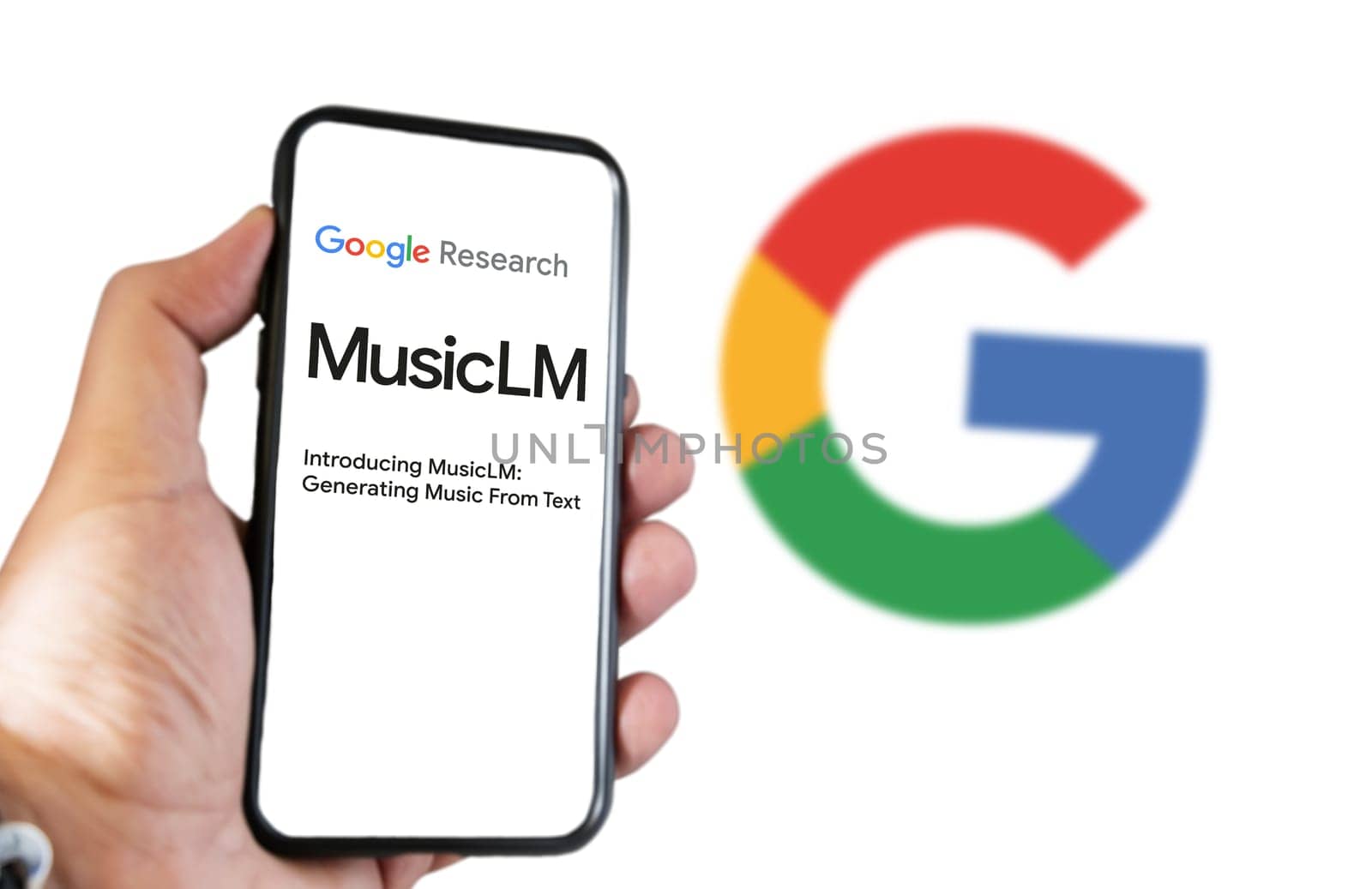 San Francisco US, Feb 2023: A hand holding a phone with the Google MusicLM website on the screen. White background with blurred Google logo. Bard is Google artificial intelligence chatbot