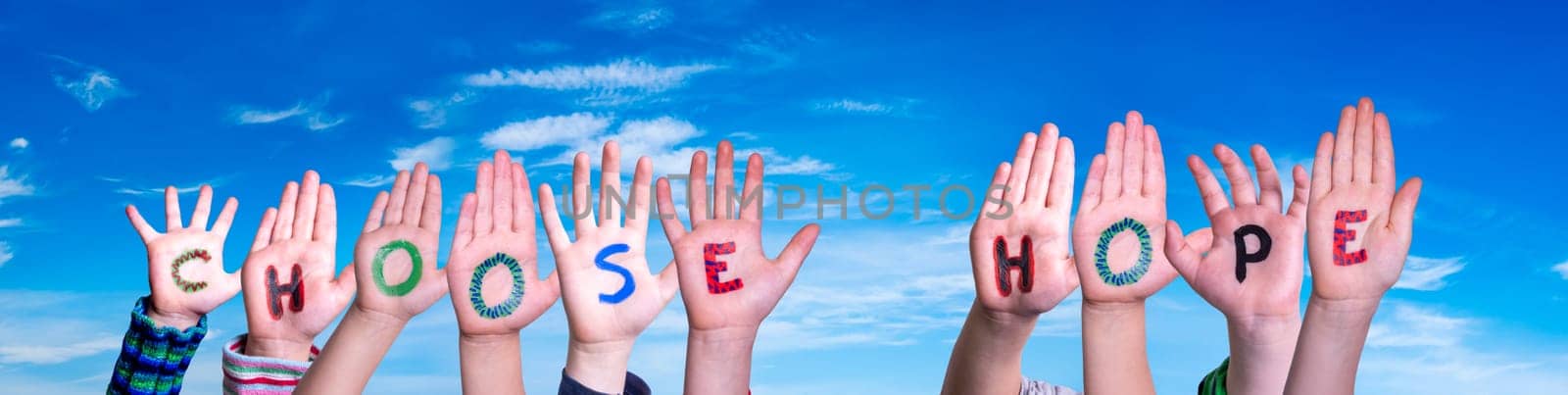 Children Hands Building Colorful English Word Choose Hope. Blue Sky As Background.